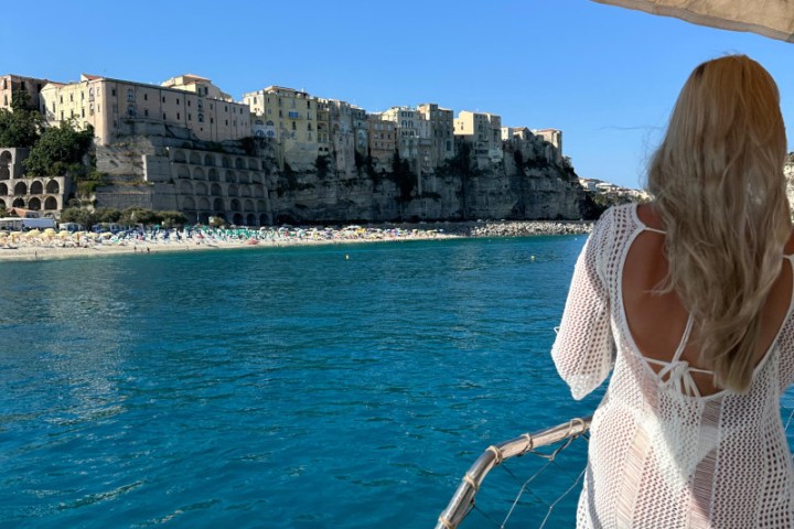 a person standing on a boat in the water