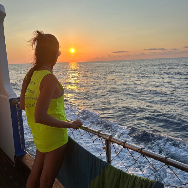 a woman standing next to a body of water