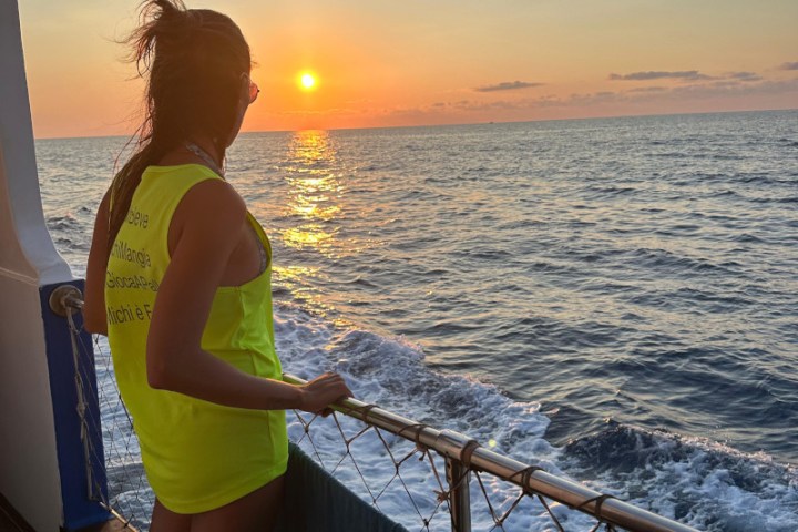 a woman standing next to a body of water